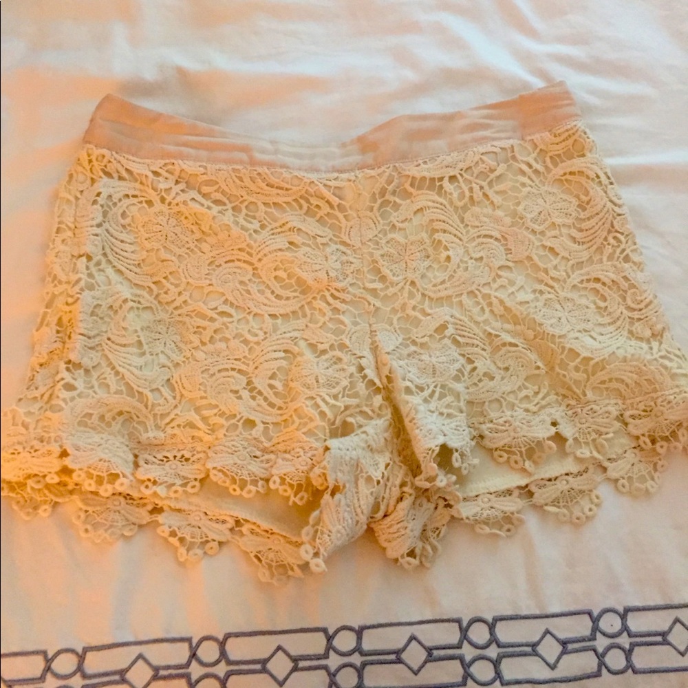Cream colored shorts. Embroidery design